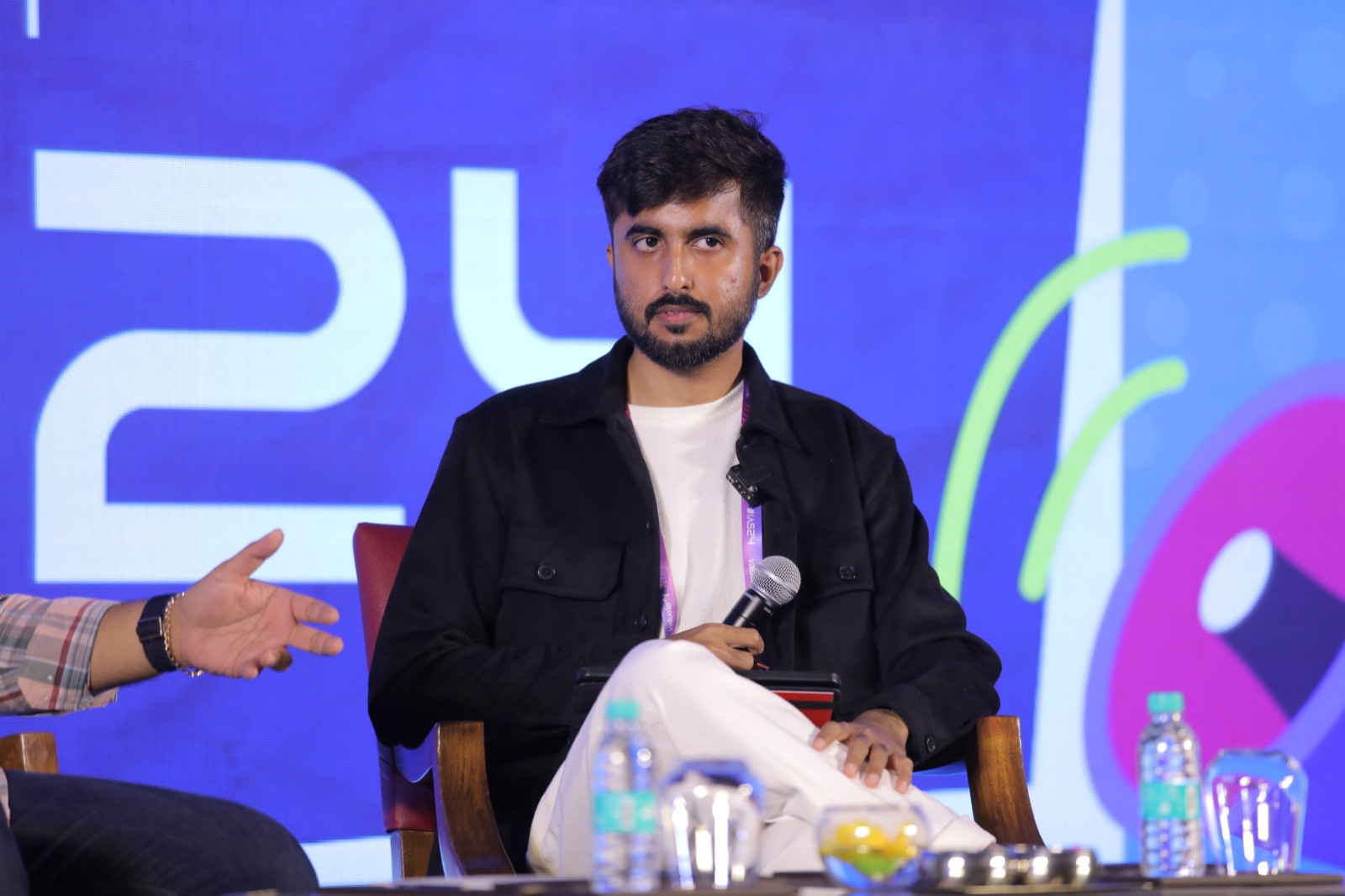 Piyush Kukreja mid-talk on stage, microphone in hand