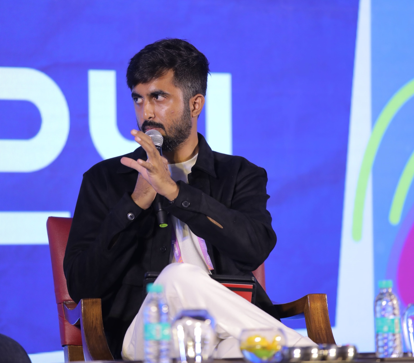 Piyush Kukreja with a microphone on stage